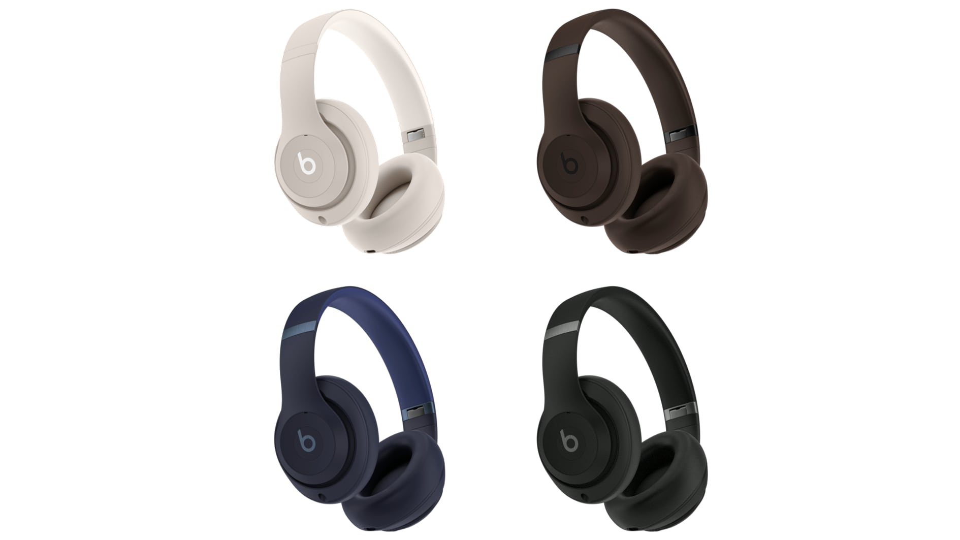 Four Beats Studio Pro over-ear headphones in white, brown, dark blue and black, set against a white background